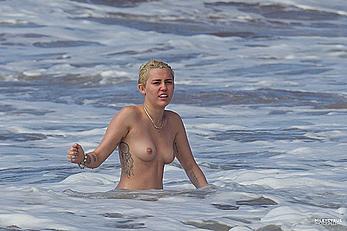 Miley Cyrus caught topless on a beach in Hawaii