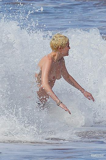 Miley Cyrus caught topless on a beach in Hawaii