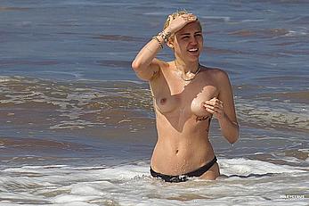 Miley Cyrus caught topless on a beach in Hawaii