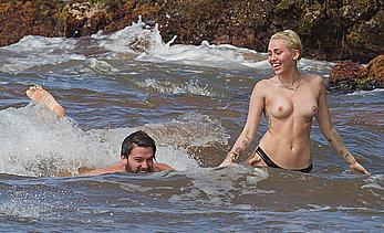 Miley Cyrus caught topless on a beach in Hawaii