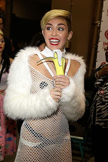 Miley Cyrus withiut bra under see through fishnet dress at The iHeartRadio Music Festival