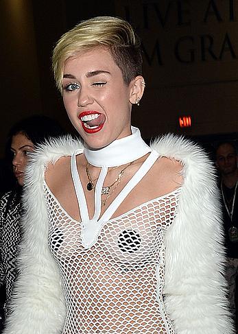 Miley Cyrus withiut bra under see through fishnet dress at The iHeartRadio Music Festival