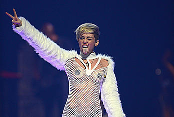 Miley Cyrus withiut bra under see through fishnet dress at The iHeartRadio Music Festival