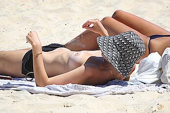 Montana Cox sunbathing topless on a beach in Sydney