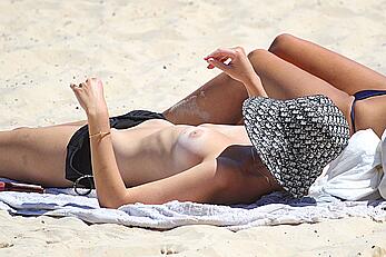 Montana Cox sunbathing topless on a beach in Sydney