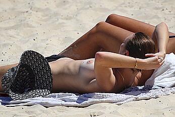 Montana Cox sunbathing topless on a beach in Sydney