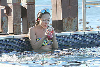 Myleene Klass seen on holiday by the pool in a bikini