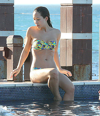 Myleene Klass seen on holiday by the pool in a bikini