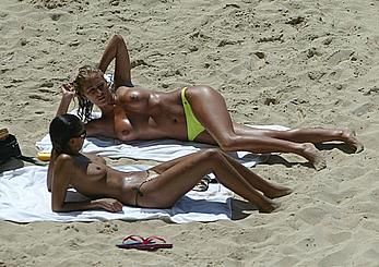 Naomi Ryan and Katy Edwards subathing topless on a beach