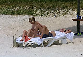 Natalie Appleton sunbathing topless on a beach