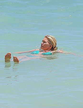 Natasha Henstridge in blue bikini at a beach in Hawaii