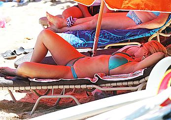 Natasha Henstridge in blue bikini at a beach in Hawaii