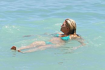 Natasha Henstridge in blue bikini at a beach in Hawaii