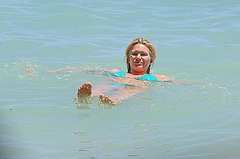 Natasha Henstridge in blue bikini at a beach in Hawaii