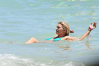 Natasha Henstridge in blue bikini at a beach in Hawaii