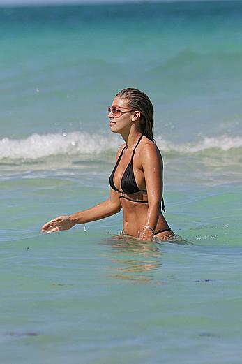 Natasha Oakley black bikini on a beach in Miami