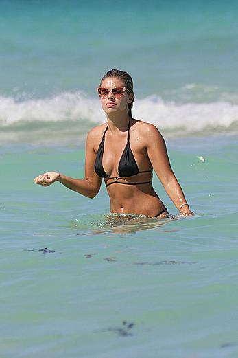 Natasha Oakley black bikini on a beach in Miami