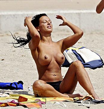 Nereida Gallardo sunbathing topless on a beach