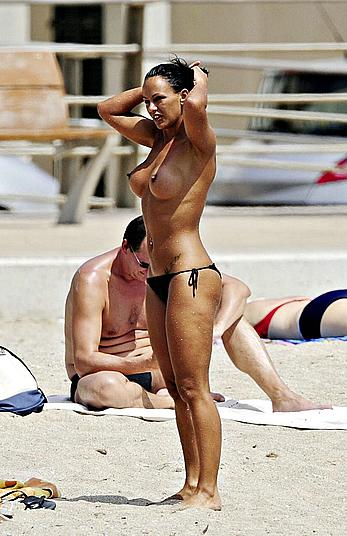 Nereida Gallardo sunbathing topless on a beach