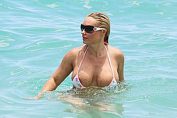 Nicole Coco Austin in a thong bikini shows areola slip in Miami Beach