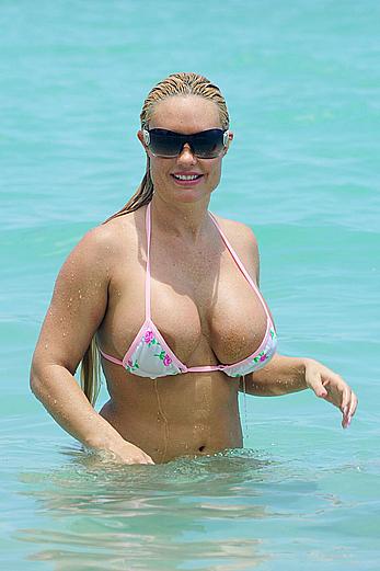 Nicole Coco Austin in a thong bikini shows areola slip in Miami Beach