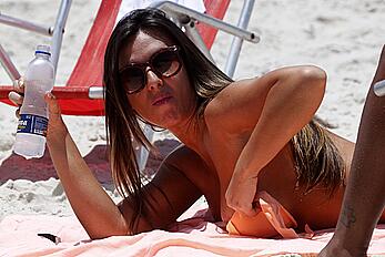 Nicole Bahls sunbathing topless on a beach in Barra da Tijuca, Rio de Janeiro