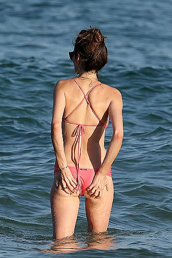 Nicole Trunfio cleavage and hard nipps in a pink bikini at Bondi Beach in Sydney