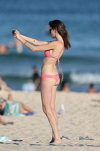 Nicole Trunfio cleavage and hard nipps in a pink bikini at Bondi Beach in Sydney