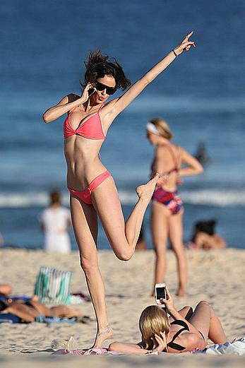 Nicole Trunfio cleavage and hard nipps in a pink bikini at Bondi Beach in Sydney