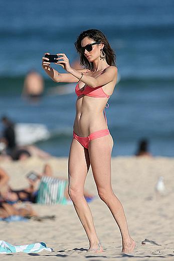 Nicole Trunfio cleavage and hard nipps in a pink bikini at Bondi Beach in Sydney