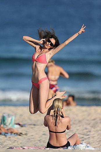 Nicole Trunfio cleavage and hard nipps in a pink bikini at Bondi Beach in Sydney