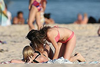 Nicole Trunfio cleavage and hard nipps in a pink bikini at Bondi Beach in Sydney