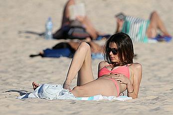 Nicole Trunfio cleavage and hard nipps in a pink bikini at Bondi Beach in Sydney