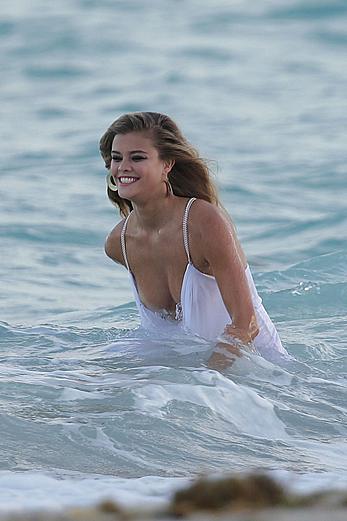 Nina Agdal titslip during photoshoot for Bebe on the beach in Miami