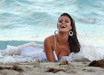 Nina Agdal titslip during photoshoot for Bebe on the beach in Miami