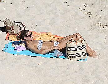 Olivia Palermo sunbathing without bra on the beach in St. Barths