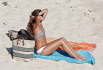 Olivia Palermo sunbathing without bra on the beach in St. Barths