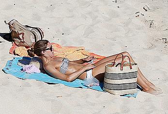 Olivia Palermo sunbathing without bra on the beach in St. Barths