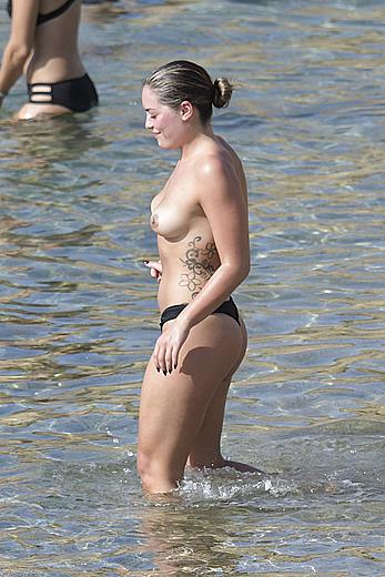 Olympia Valance topless on a beach in Greece