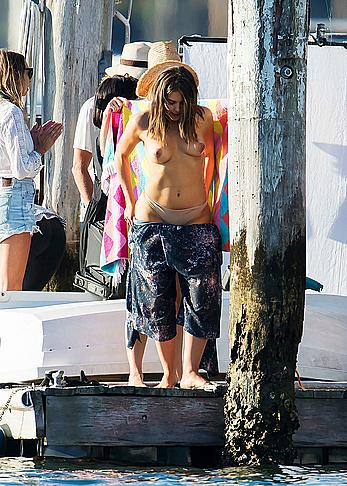 Olympia Valance topless while changing for a photoshoot