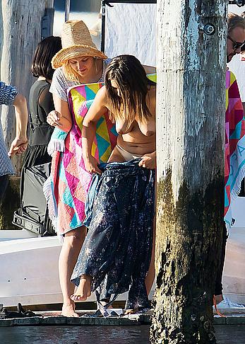 Olympia Valance topless while changing for a photoshoot