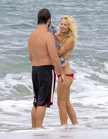 Busty Pamela Anderson goes topless on a beach in France