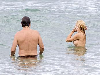 Busty Pamela Anderson goes topless on a beach in France