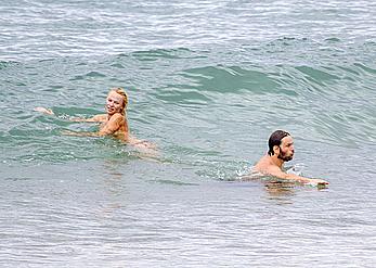 Busty Pamela Anderson goes topless on a beach in France