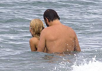 Busty Pamela Anderson goes topless on a beach in France