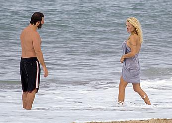 Busty Pamela Anderson goes topless on a beach in France