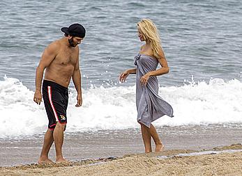 Busty Pamela Anderson goes topless on a beach in France