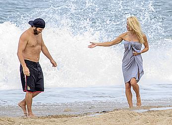 Busty Pamela Anderson goes topless on a beach in France