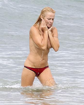 Busty Pamela Anderson goes topless on a beach in France