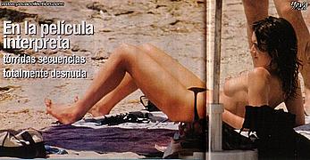 Paz Vega sunbathing topless on a beach